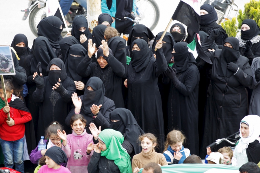 Protesters fully covered in traditional garb chant slogans during an anti-government protest in the rebel-controlled area of Maaret al-Numan town in Idlib province on March 25, 2016. Protesters fully covered in traditional garb chant slogans during an anti-government protest in the rebel-controlled area of Maaret al-Numan town in Idlib province on March 25, 2016.